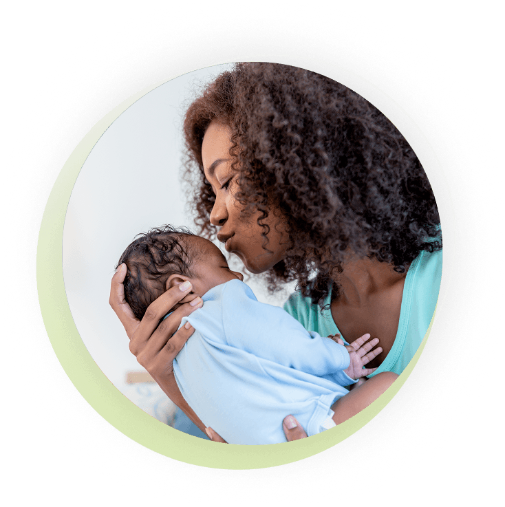 Mother holding and kissing her baby