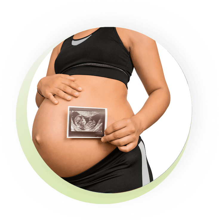 Pregnant woman holding an ultrasound scan of her baby