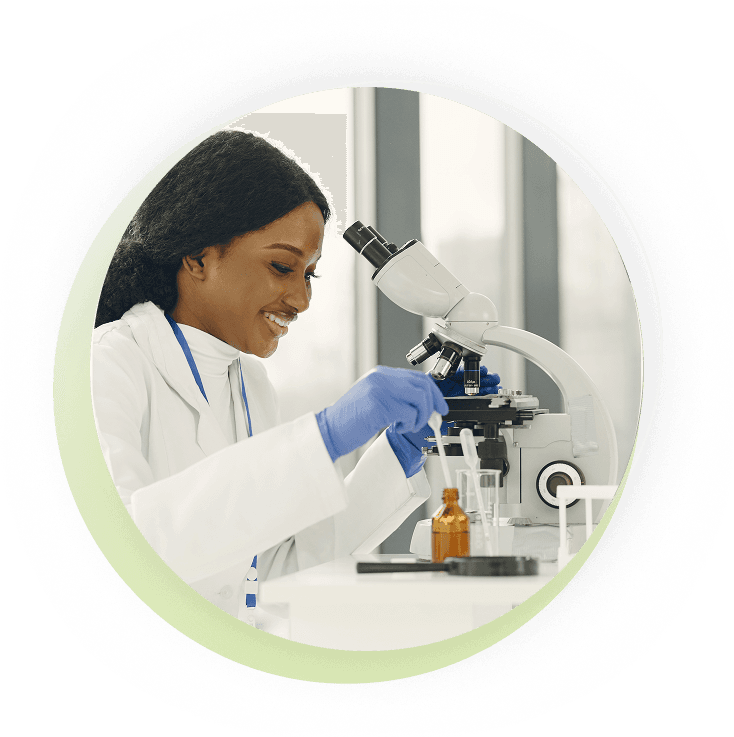 Laboratory scientist examining samples under a microscope