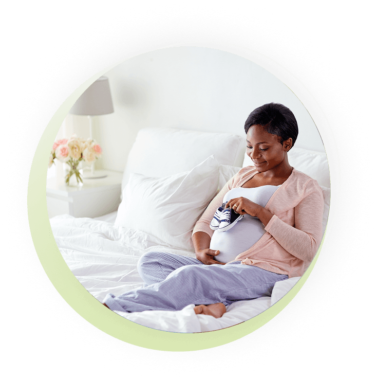Pregnant mother holding children's shoes
